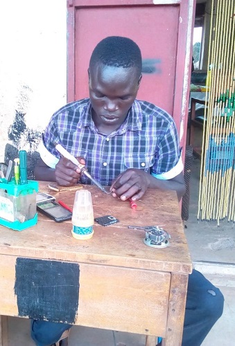 Oloya Kenneth at his workshop